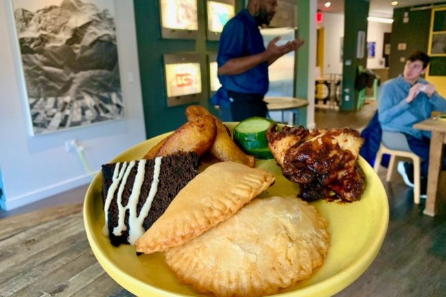 a person sitting at a table with a plate of food