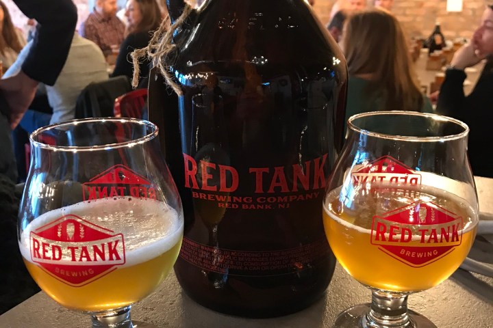 a bottle of wine and a glass of beer on a table