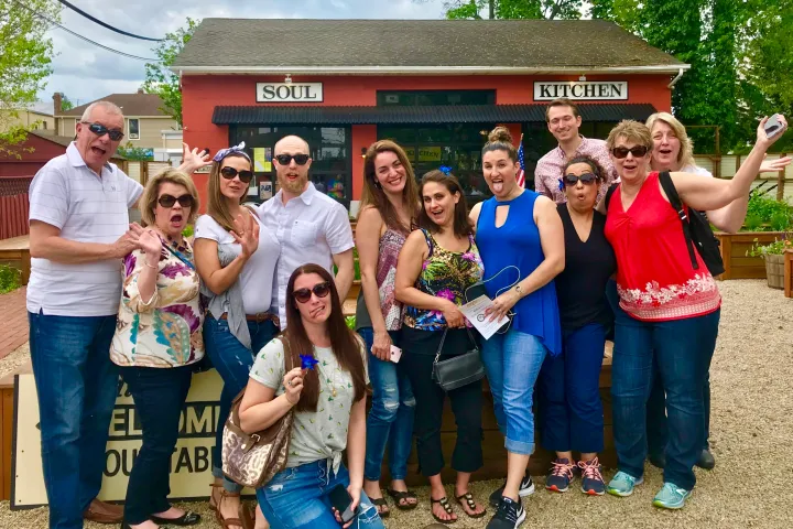 Natalie Schenken et al. posing for a photo in front of a building