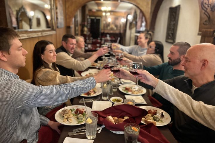 a group of people sitting at a table eating food