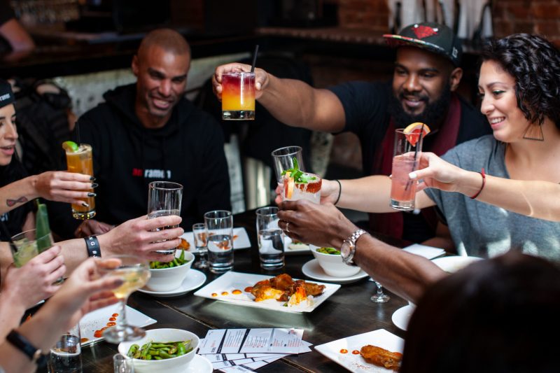 a group of people sitting at a table eating food