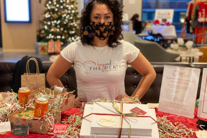a woman sitting at a table with food