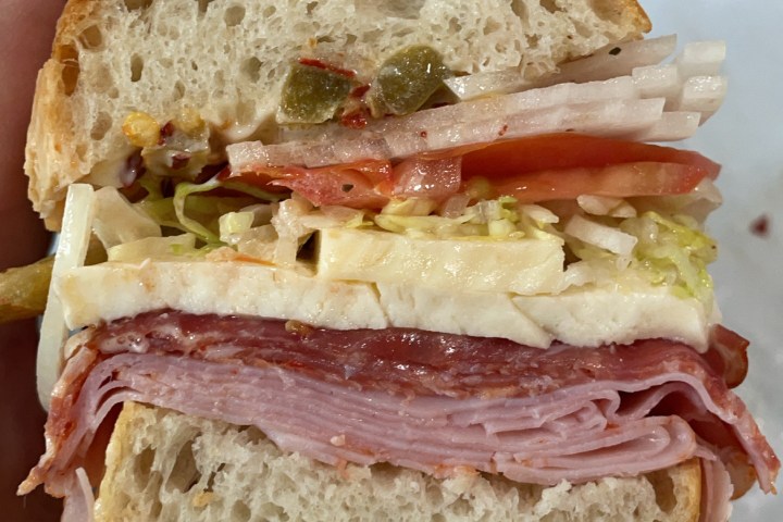 a close up of a sandwich sitting on top of a piece of paper