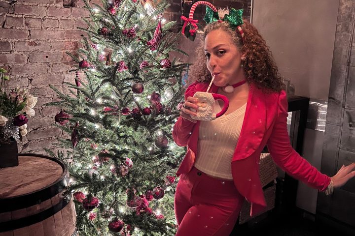 a woman sitting in a chair talking on a cell phone