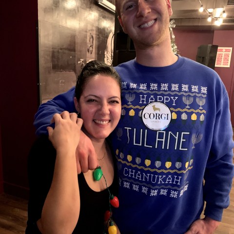 a man holding a bottle posing for the camera