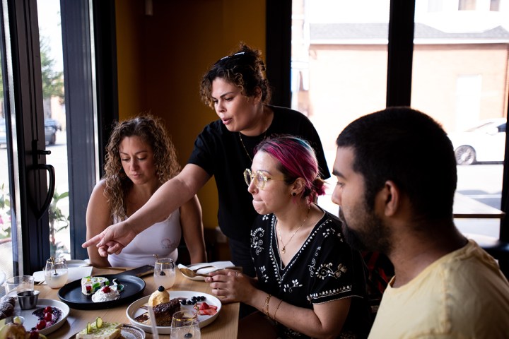 a group of people sitting at a table eating food