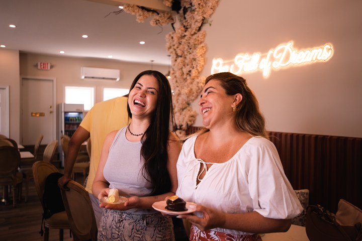 a woman standing in front of a restaurant
